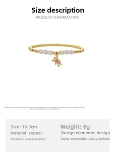 Detail of copper beaded bracelet with white pearls and a pink rhinestone bear charm
