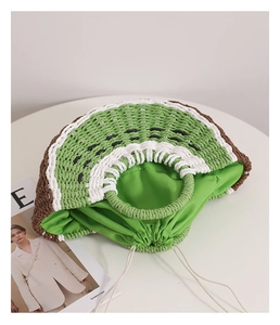 Dettaglio del motivo a fetta di kiwi e fodera con coulisse sulla borsa di paglia