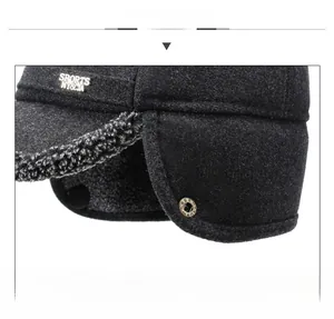 Detail of warm winter hat with thick grey wool fabric and soft fleece ear protection