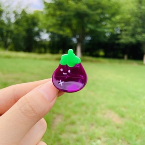 Cute purple eggplant hair clip made of acetate resin with a green stem and cartoon face