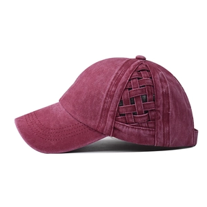 Detailed side view of burgundy washed cotton ponytail cap with woven mesh texture