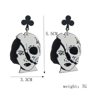 Gothic acrylic earrings featuring skull face art with 5.5cm x 3.3cm size detail
