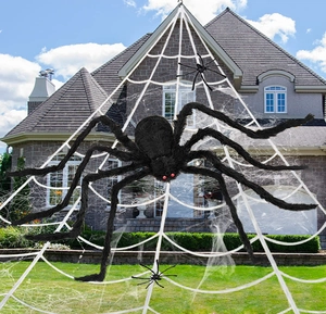 Outdoor Halloween porch decor with large white glowing spider web and plush black spiders