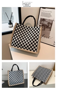 Detail of checkered tote bag with woven handles and linen side stitching for daily use