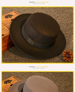 Detail of children's wool felt boater hats in black and grey with decorative bands