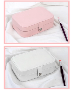 Detail view of pink and white faux leather jewelry organizers with metal snap closure