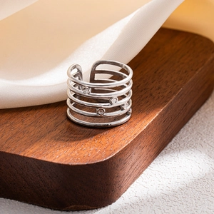 Detail shot of a silver layered open ring with multiple bands and polished studs
