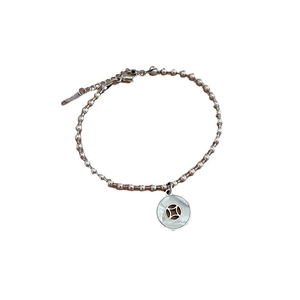 Silver bead bracelet with a round white shell pendant and metal coin accent