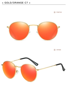 Detailed view of round gold metal sunglasses with orange mirrored lenses and black temple tips