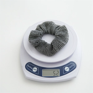 Detailed view of lightweight pleated polyester scrunchie weighing 5.2g on white scale