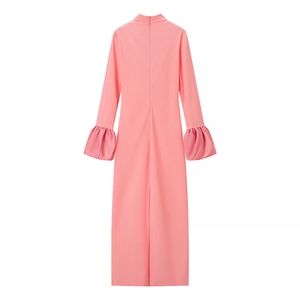 Pink high-neck maxi dress with stylish puff sleeves and ruffled cuffs on a white backdrop