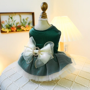 Close-up of green satin pet princess dress with tiered mesh and rhinestone bow detail
