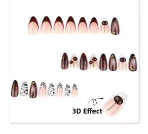 Détails de faux ongles amande avec cerises 3D et motifs zébrés noir et blanc