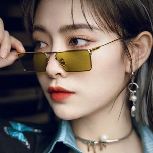 Modern rectangular sunglasses with thin gold metal frames and translucent yellow lenses