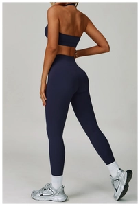 Detail view of navy blue backless yoga top and high-waisted seamless sports leggings