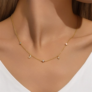 Detailed view of a gold S925 silver necklace with star, moon, and colorful diamond charms