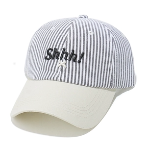 Detailed macro view of black and white striped cotton baseball cap with Shhh! embroidery