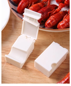 Macro shot of white plastic lobster sheller tool with ergonomic serrated peeling structure