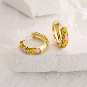 18K gold plated hoop earrings with colorful floral enamel patterns on a stone display