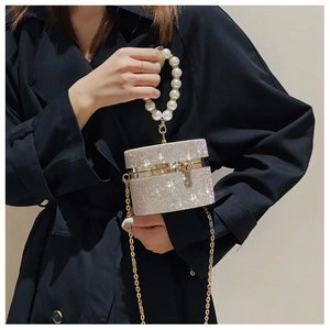 Close-up of luxury pearl handle and sparkling rhinestone evening bag with chain