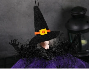 Detail of Halloween witch pendant featuring purple mesh skirt and black pointed hat