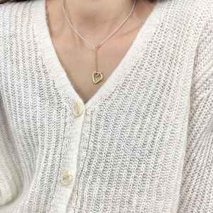 Detail view of a 925 sterling silver heart necklace with a unique two-tone gold finish