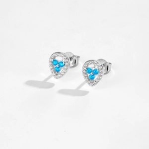 Detail of 925 sterling silver ear studs featuring blue gems and micro-set crystals