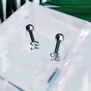 Detail of silver round zircon ear studs with secure four-prong setting and ball screw back