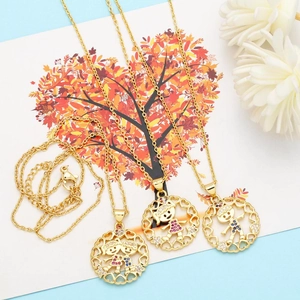 Detail of cute gold heart pendants featuring boy and girl charms with enamel inlay