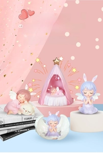 Macro view of four angel girl resin figurines in dreamlike pink nursery decor