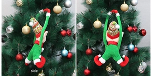 Detail view showing the side and back of a plush Christmas elf doll hanging on a festive tree