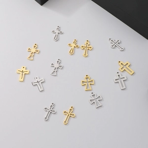Detailed macro view of assorted stainless steel cross pendants in gold and silver finishes