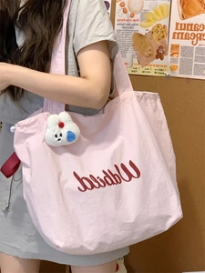 Pink canvas tote bag featuring a cute bunny pendant and cursive Waldied lettering