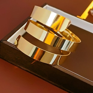 Macro shot of gold-plated multi-layer spiral cuff bracelet with a polished mirror finish