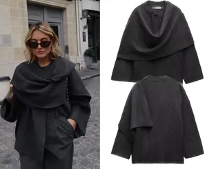 Detail showing charcoal grey shawl-collar knit cardigan with wide sleeves and open front