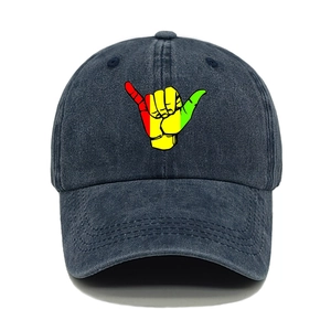 Detail of vintage washed baseball cap featuring a three-color Shaka hand sign embroidery