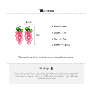 Macro view of pink resin grape earrings with dimensions showing size and materials