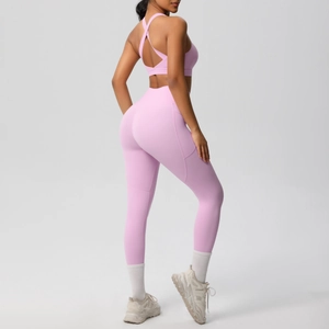 Detail of lavender yoga set featuring cross-back sports bra and high-waisted side pocket leggings