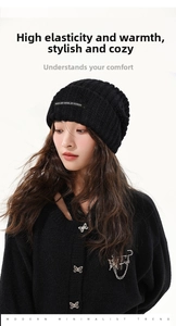 Detail of black ribbed knit beanie with Unique and Casual textile label patch