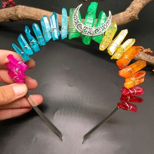 Macro detail of handmade rainbow crystal crown with moon ornament and silver metal wire wrapping