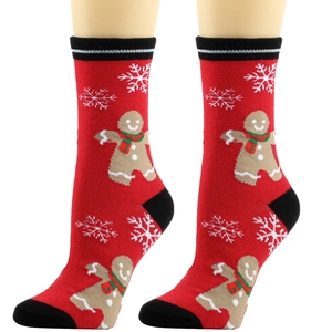 Close-up of Christmas crew socks with gingerbread man and snowflake patterns on red knit