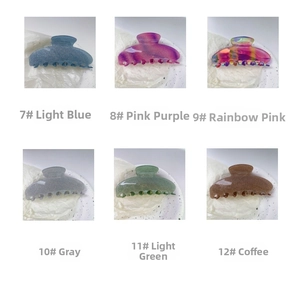 Detail view of six Y2K star-pattern hair claws in blue, purple, pink, gray, green, and brown