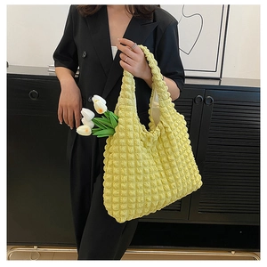 Detail of yellow puffy cloud tote bag showing ruffled texture and spacious interior