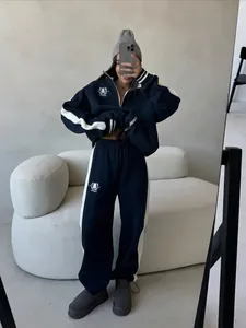 Women's navy two-piece tracksuit with white stripes, half-zip sweatshirt and wide-leg pants