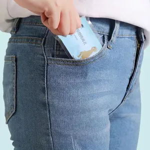 Portable disposable blue raincoat in compact card packaging fitting into a pocket