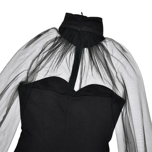 Detail of black mesh patchwork dress featuring a high collar and zipper closure