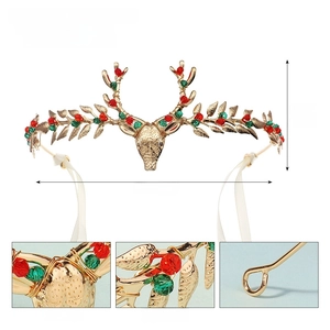 Detail of deer antler tiara with red and green crystals on hand-woven gold wire