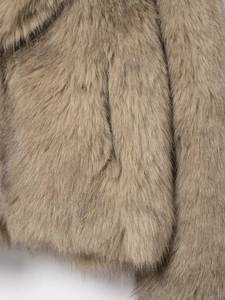 Detailed macro view showing the soft texture and fluffy fibers of khaki faux fur coat