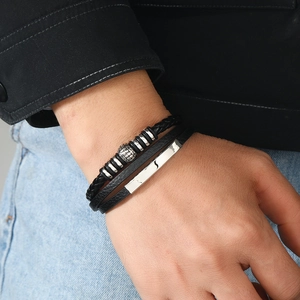 Close-up of black braided leather bracelet with silver lion head and magnetic alloy clasp