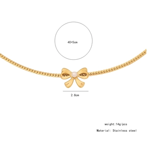 Detail view of a 2.8cm bow pendant with faux pearl on a 40+5cm stainless steel chain
